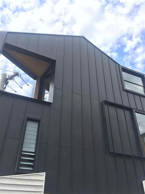 black raised seam metal siding historic house|black siding ideas for homes.